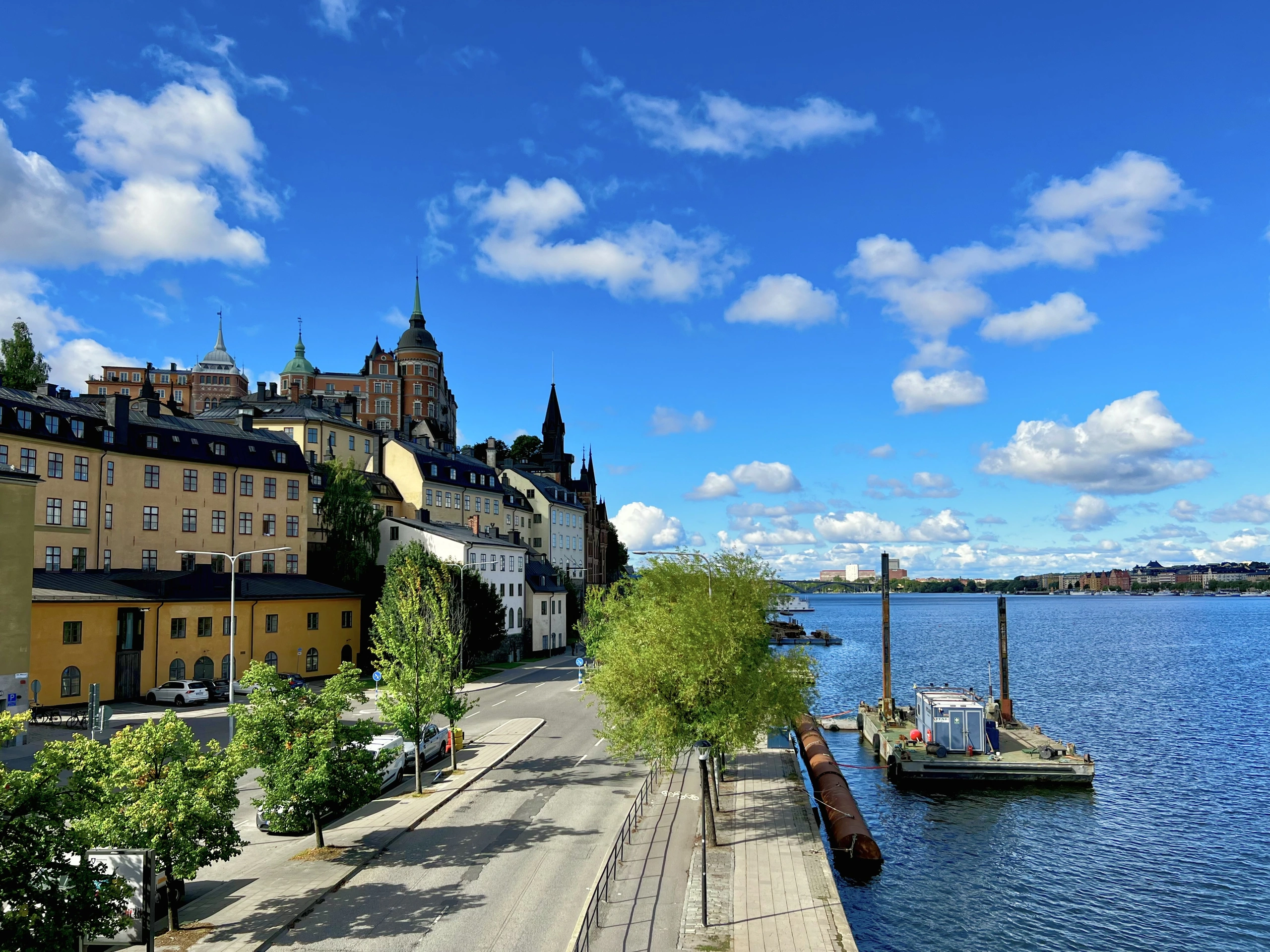 Colourful buildings on Södermalm beside blue water under a bright sky